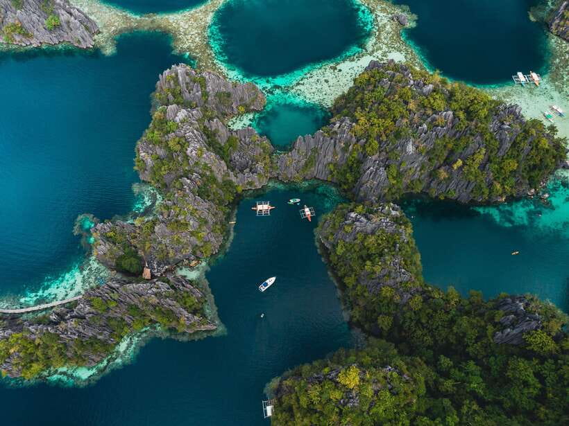 Coron: Private Island-Hopping Tour on a Yacht or Speedboat - Leaving Coron Harbor Square for a full day at sea