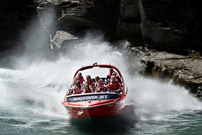 A speedboat under power off a limestone coast