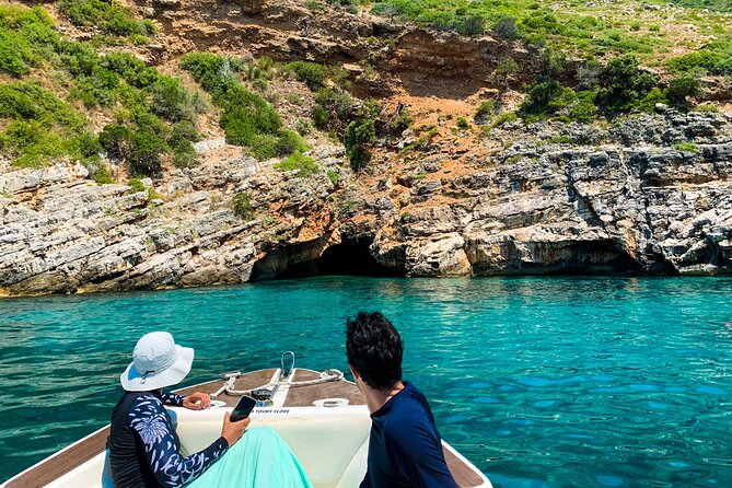 Vlore Private Boat Tour Blue Cave & Grama Bay Adventure - Bristani Bay adds bunkers to the beach scenery